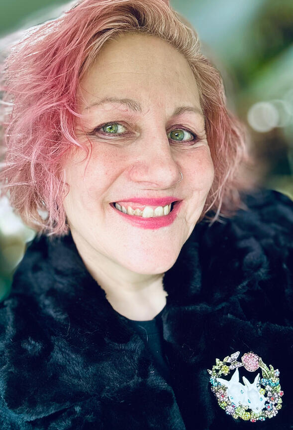 Mandy Millie Flockton selfie image 3/4 profile smiling pink hair bunnies brooch